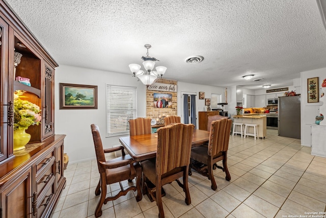 dining room with light tile patterned floors, a textured ceiling, and an inviting chandelier