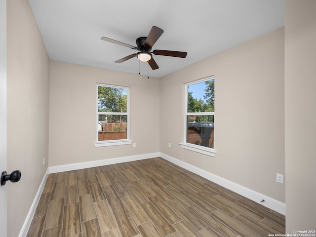 spare room with hardwood / wood-style flooring and ceiling fan