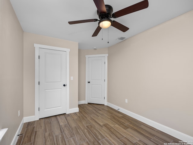 unfurnished bedroom featuring a closet, ceiling fan, and light hardwood / wood-style flooring