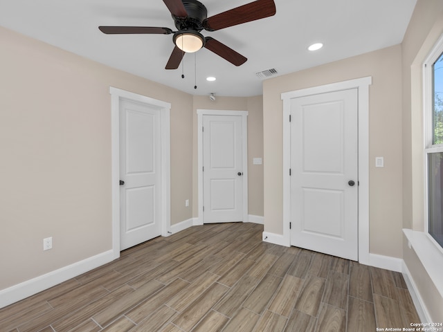 unfurnished bedroom featuring light hardwood / wood-style flooring and ceiling fan