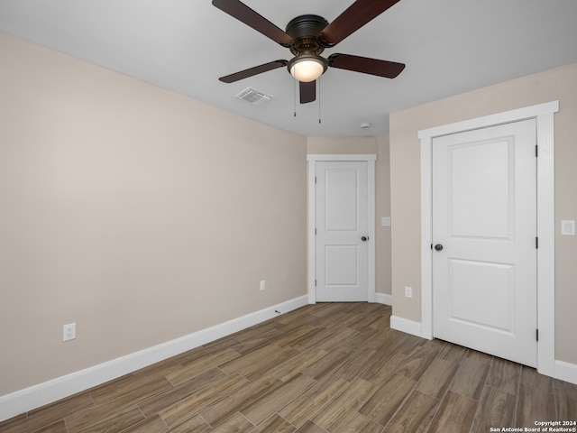 unfurnished bedroom with hardwood / wood-style flooring and ceiling fan