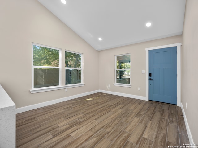 foyer featuring high vaulted ceiling and hardwood / wood-style flooring