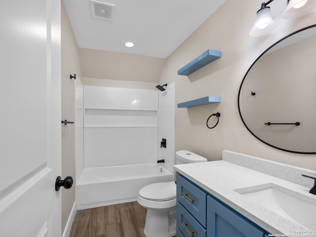 full bathroom featuring shower / bathing tub combination, hardwood / wood-style floors, vanity, and toilet