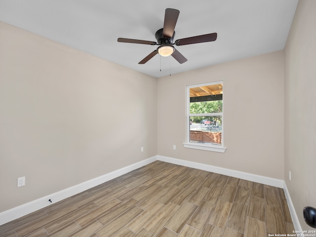 spare room with light hardwood / wood-style floors and ceiling fan