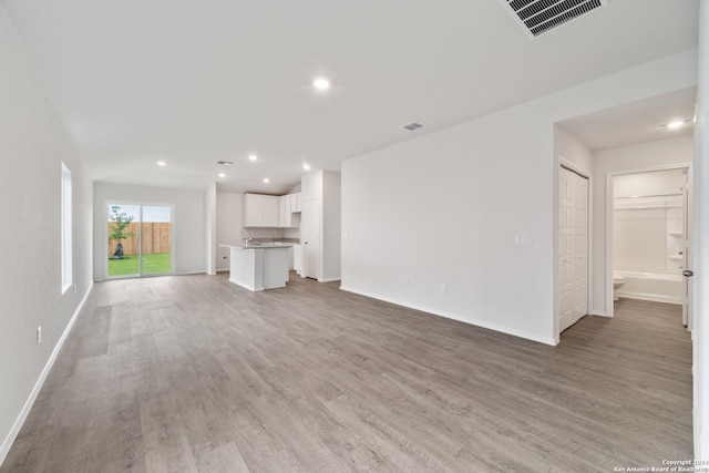 unfurnished living room featuring light hardwood / wood-style floors