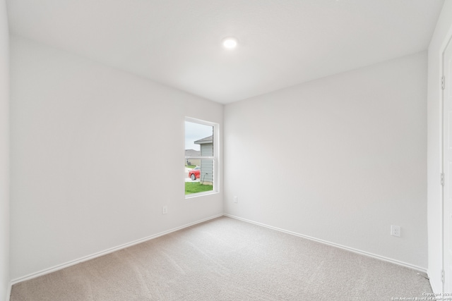 unfurnished room with light carpet