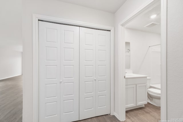 bathroom featuring hardwood / wood-style floors, vanity, and toilet