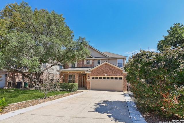 view of front of property featuring a garage and a front lawn