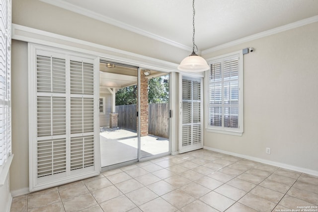 unfurnished dining area with light tile patterned flooring and ornamental molding