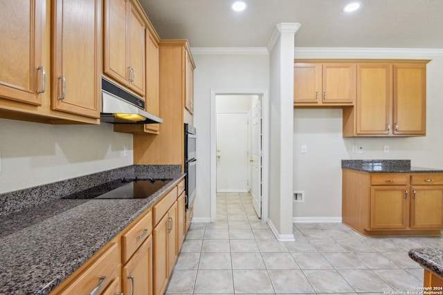 kitchen featuring dark stone counters, light tile patterned floors, and ornamental molding