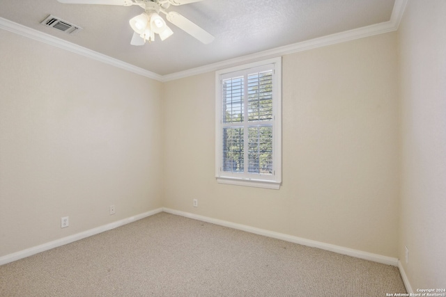 carpeted empty room featuring ceiling fan, a textured ceiling, and ornamental molding