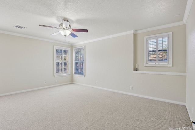 spare room with a textured ceiling, carpet floors, ceiling fan, and crown molding