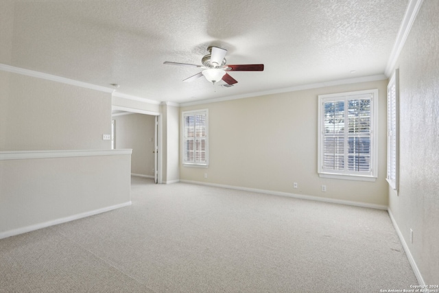 carpeted empty room with ceiling fan, a textured ceiling, and ornamental molding