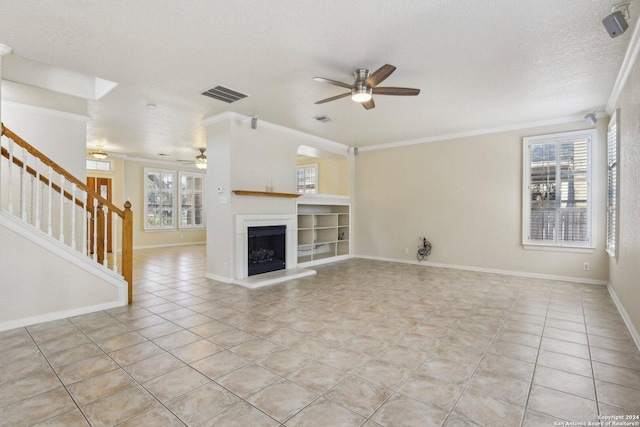 24434 Brazos Stage, San Antonio, TX 78255 - unfurnished living room featuring a ceiling fan, crown molding, stairway, plenty of natural light, and a textured ceiling