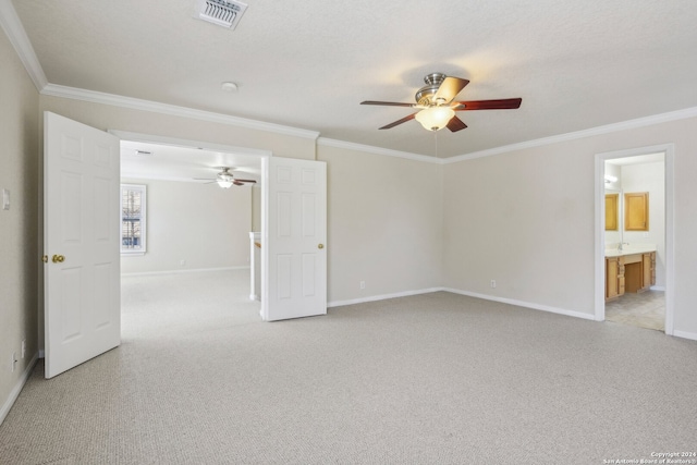 carpeted empty room featuring ornamental molding, a textured ceiling, and ceiling fan