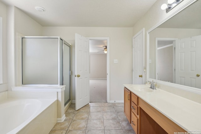 bathroom featuring ceiling fan, a textured ceiling, independent shower and bath, vanity, and tile patterned floors