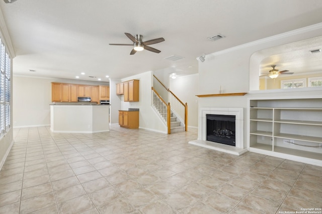 unfurnished living room with light tile patterned floors, ceiling fan, and crown molding