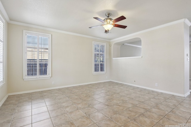 tiled empty room with ornamental molding and ceiling fan