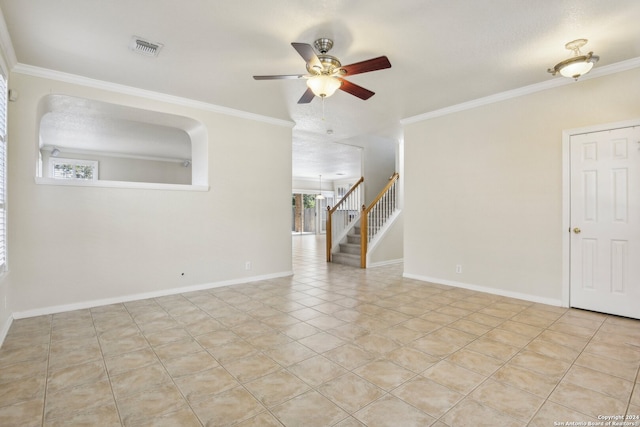 empty room featuring ornamental molding, ceiling fan, and a healthy amount of sunlight