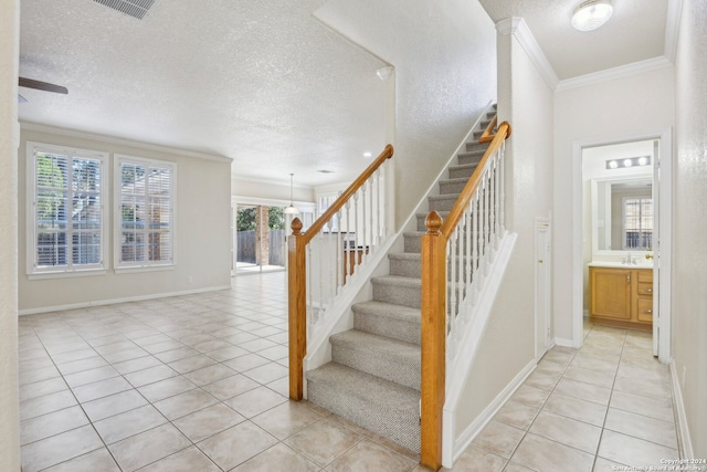 stairs featuring tile patterned flooring and a wealth of natural light