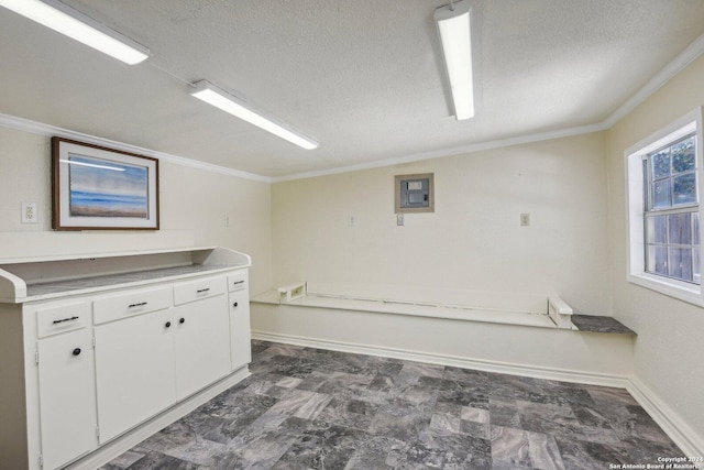 24434 Brazos Stage, San Antonio, TX 78255 - laundry room featuring crown molding, a textured ceiling, baseboards, electric panel, and dark marble finish floors