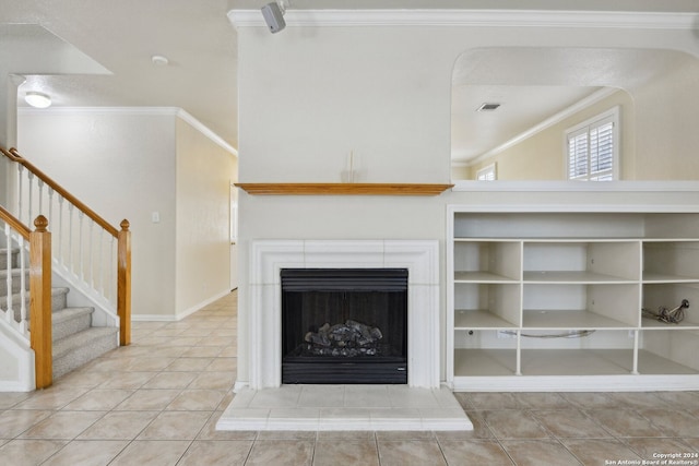 unfurnished living room featuring a tiled fireplace, light tile patterned floors, and crown molding