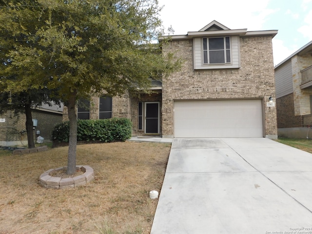 view of front of property featuring a front yard and a garage