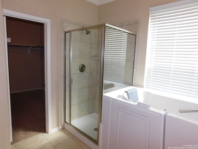 bathroom with tile patterned floors and shower with separate bathtub