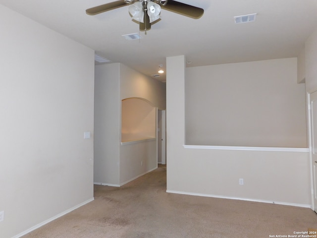 empty room with light colored carpet and ceiling fan