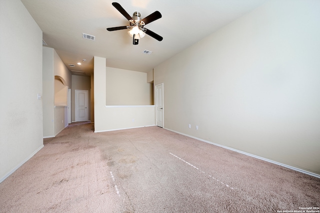 spare room with light colored carpet and ceiling fan