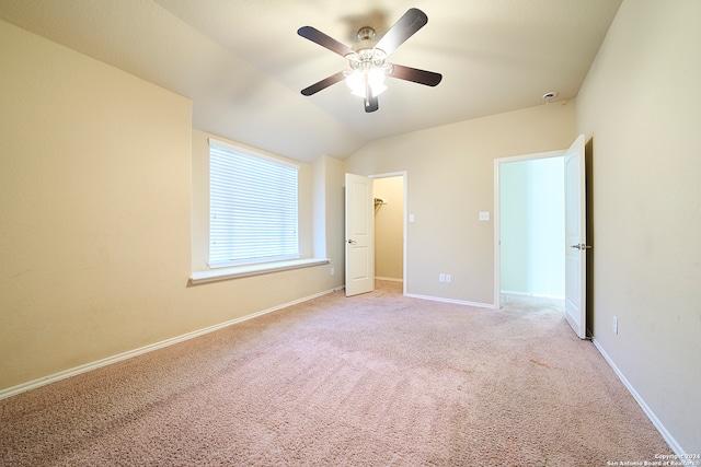 unfurnished bedroom with light carpet, vaulted ceiling, and ceiling fan