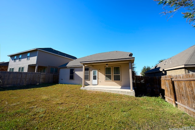 rear view of house featuring a lawn, a patio area, and ceiling fan