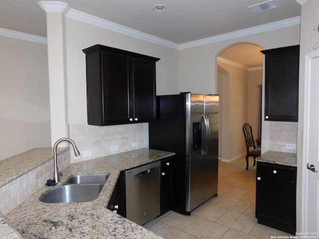 kitchen featuring decorative backsplash, sink, ornamental molding, and appliances with stainless steel finishes