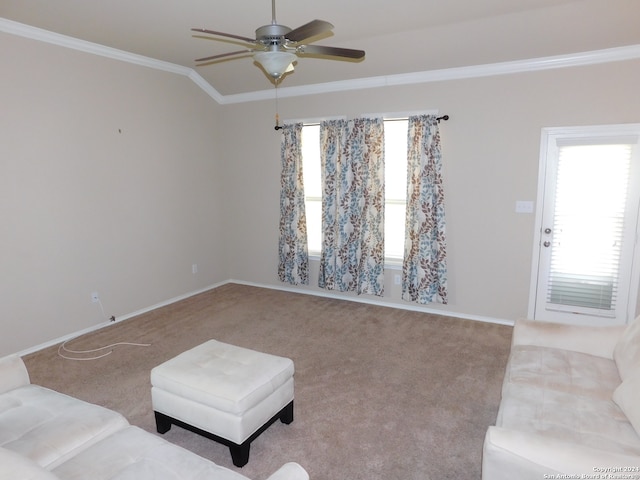 carpeted living room with ceiling fan, lofted ceiling, and crown molding