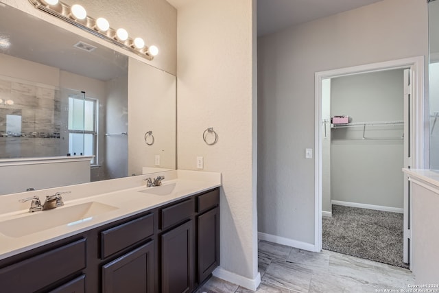 bathroom with a shower and vanity