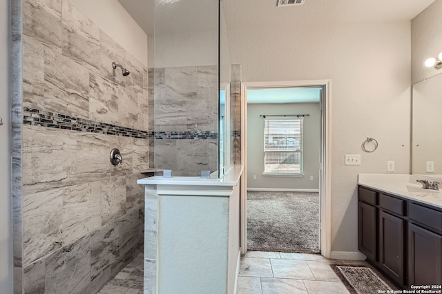 bathroom featuring vanity and tiled shower