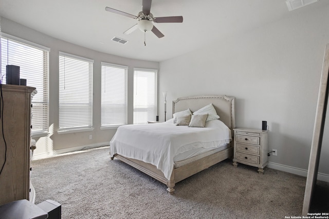 bedroom with carpet, multiple windows, and ceiling fan