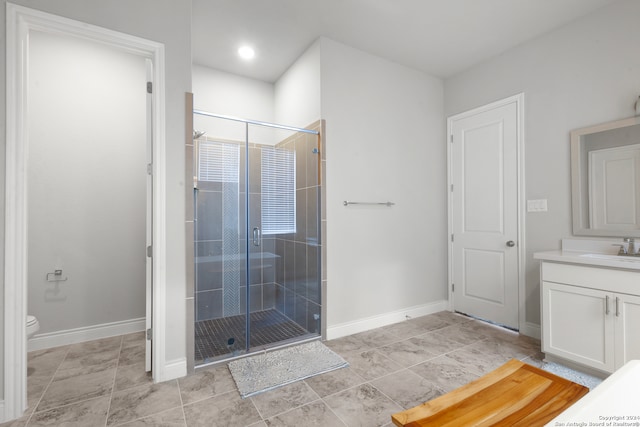 bathroom featuring tile patterned flooring, vanity, toilet, and an enclosed shower