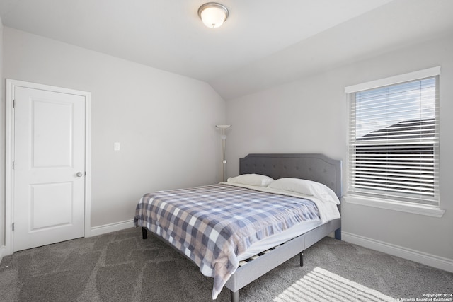 carpeted bedroom featuring lofted ceiling