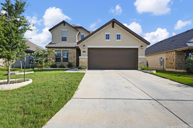 view of front of home featuring a front lawn and a garage