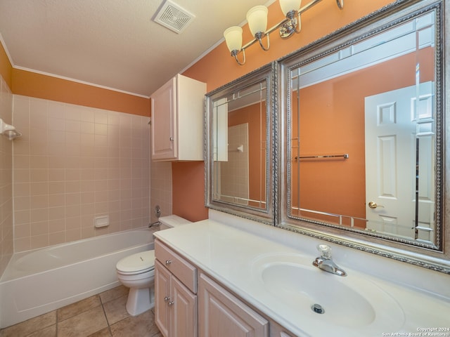 full bathroom featuring toilet, tile patterned flooring, tiled shower / bath, a textured ceiling, and vanity