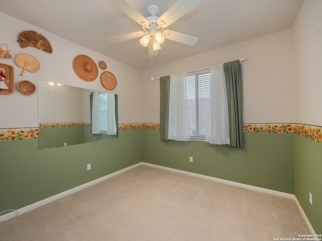 carpeted empty room with ceiling fan