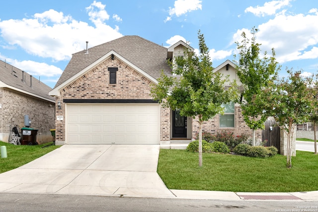 view of front of home with a garage and a front yard