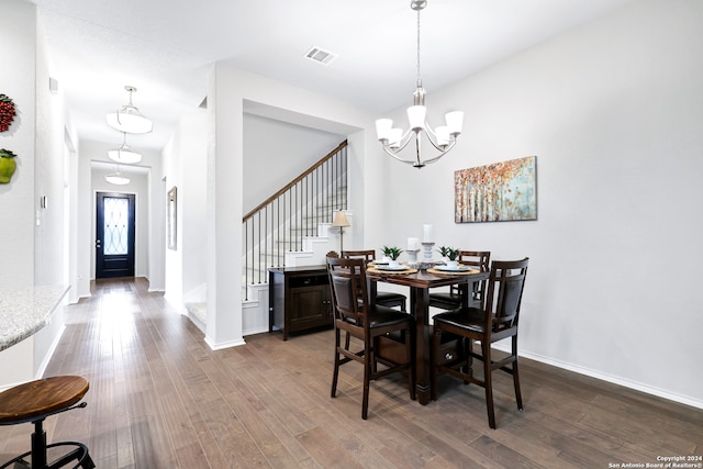 dining space featuring a notable chandelier and dark hardwood / wood-style floors