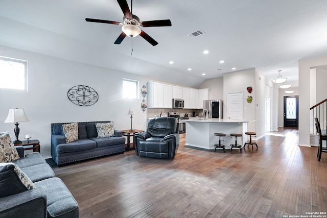 living room with dark wood-type flooring and ceiling fan