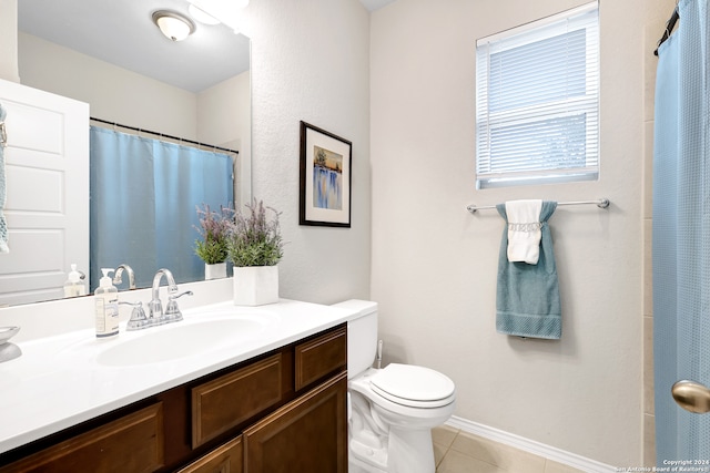 bathroom featuring vanity, tile patterned flooring, and toilet