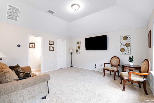 living area featuring vaulted ceiling and carpet floors