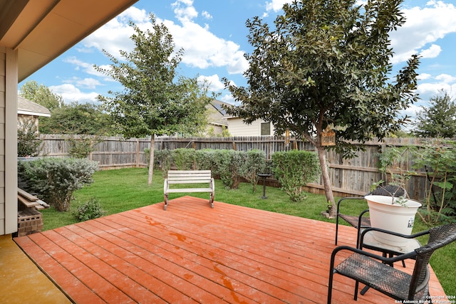 wooden terrace featuring a yard