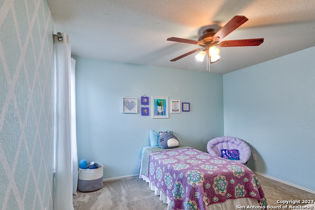 carpeted bedroom with ceiling fan