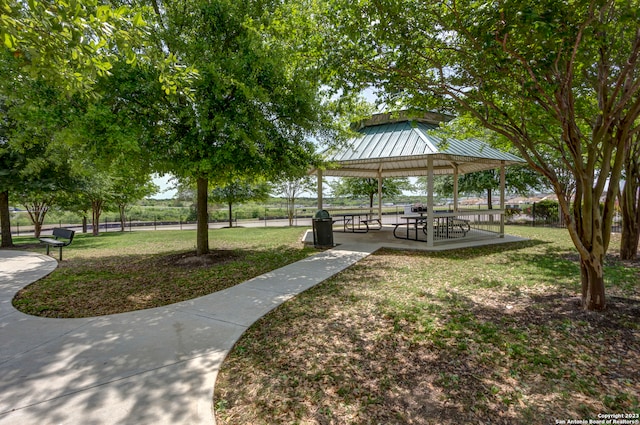 view of property's community with a lawn and a gazebo